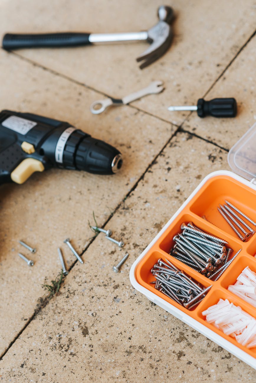 repair tools in container with hammer and screwdriver