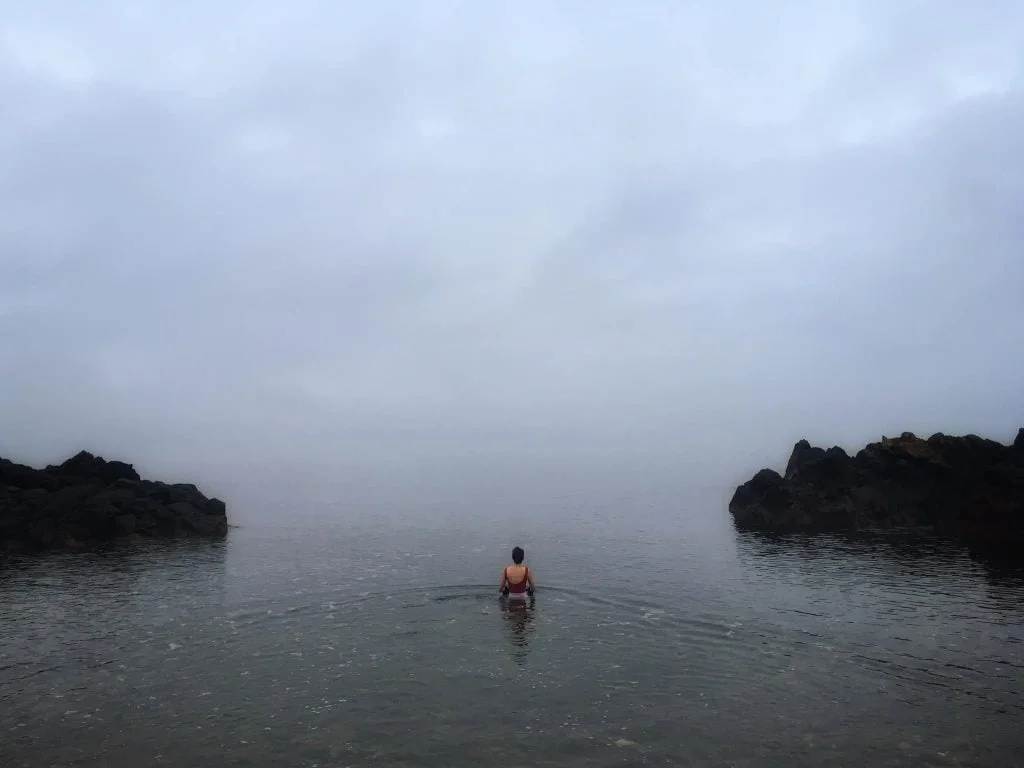 figure walking away into the sea